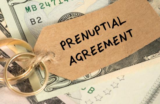 Prenuptial Agreement overlayed with two wedding rings