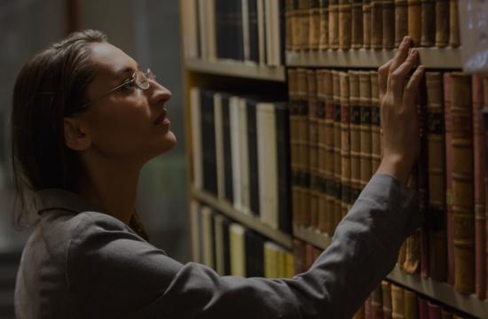 woman looking at legal books in library